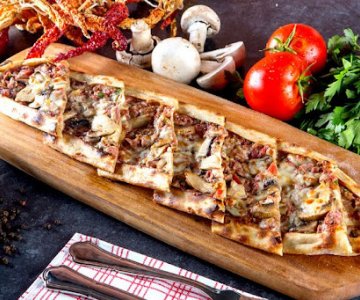Kuşbaşılı Kaş. Pide - A Turkish style pizza with meat cubes and melted mild cheddar on top